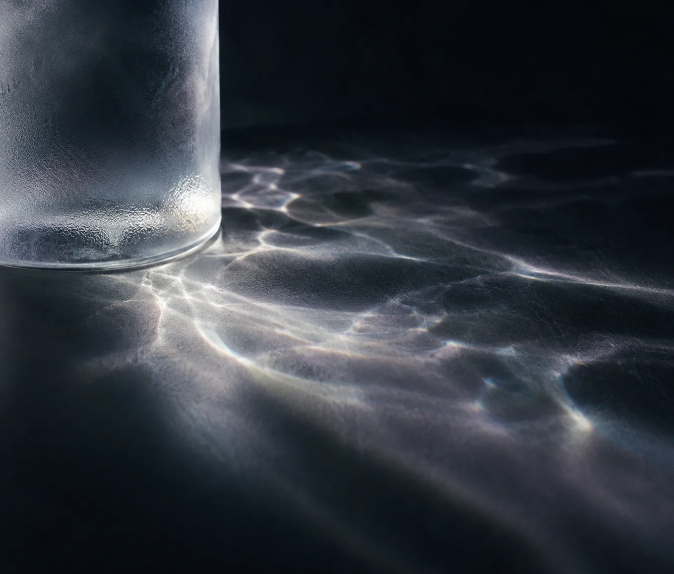 Soft light patterns cast through frosted glass and water